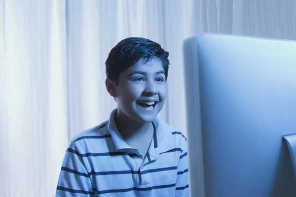 Boy looking at a computer monitor