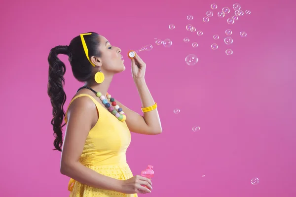 Woman blowing bubbles