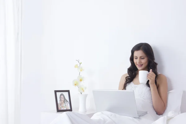 Woman with mug  and laptop