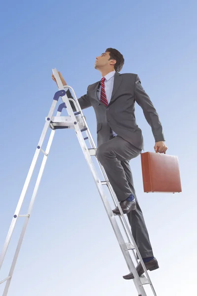 Businessman  climbing ladder