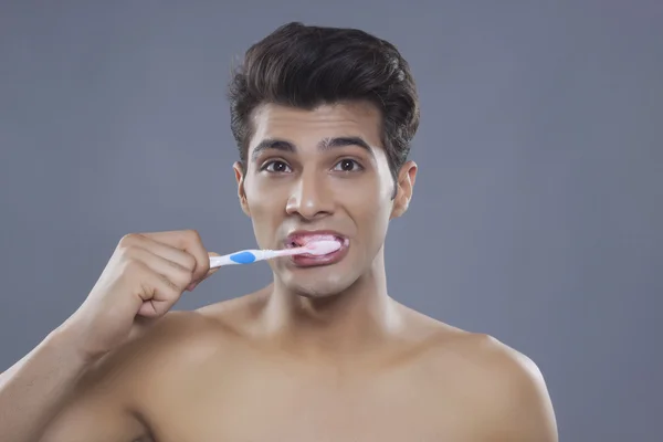 man brushing teeth