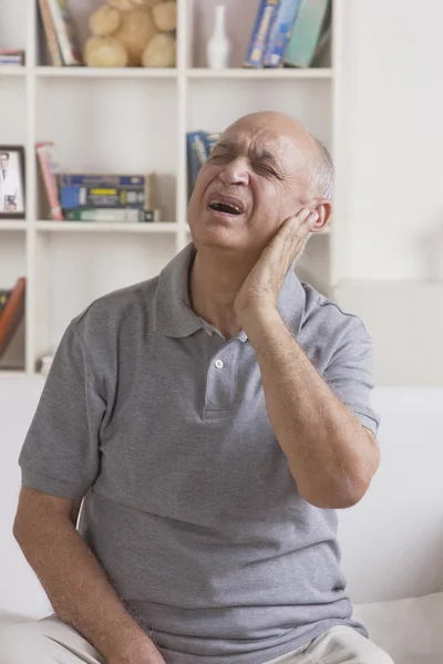 Old man with pain in ear