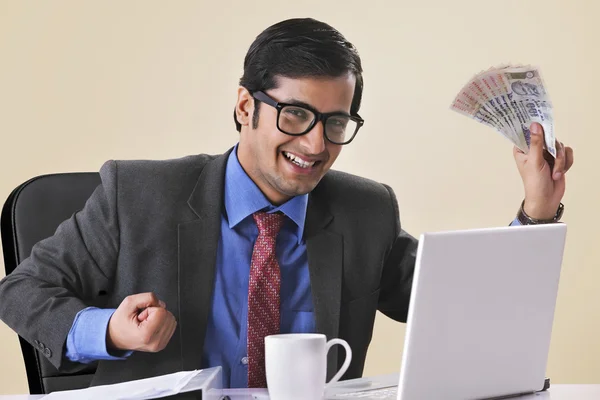 Successful businessman holding banknotes