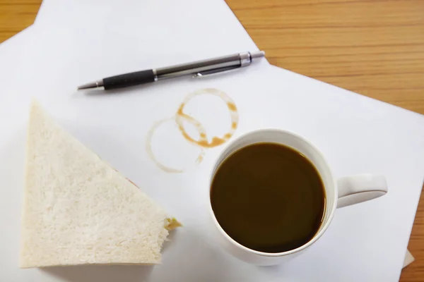 Coffee and sandwich on desk
