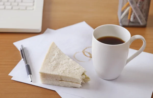 Coffee and sandwich on desk