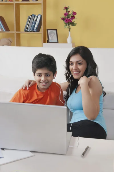 Sister and brother watching laptop