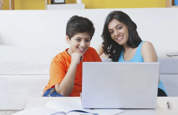 Sister and brother watching laptop