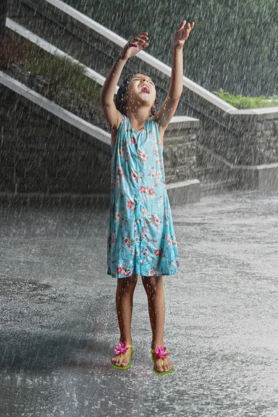 Girl playing in the rain