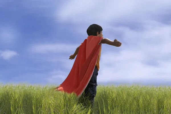 Child posing as Superman