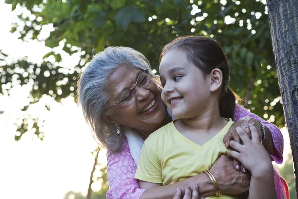 Grandmother hugging granddaughter