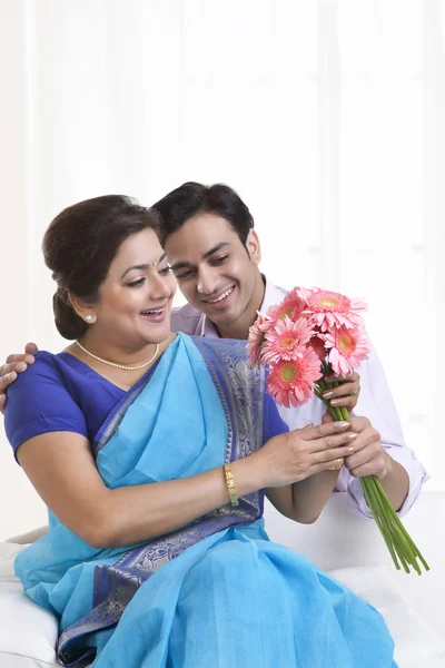 Son giving his mother flowers