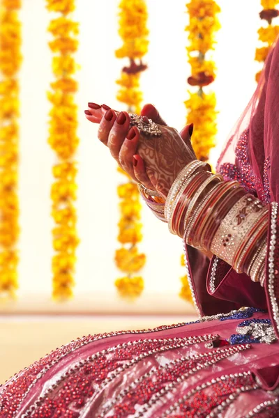 Hands in wedding bangles and ring