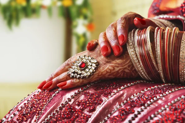 Hands in wedding bangles and ring