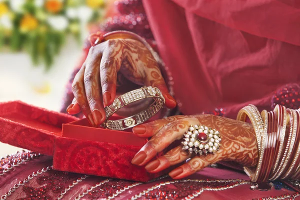 Bride\'s hands taking bangle