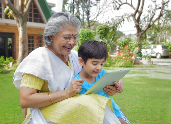 Grandmother and grandson with digital tablet