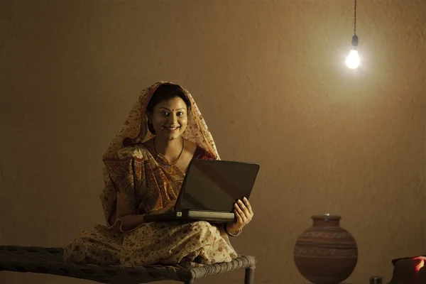 Rural woman holding laptop