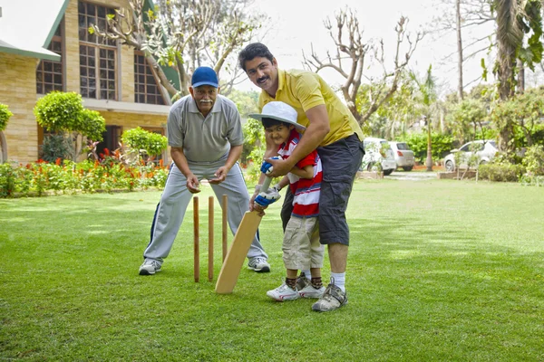 Young boy playing cricket
