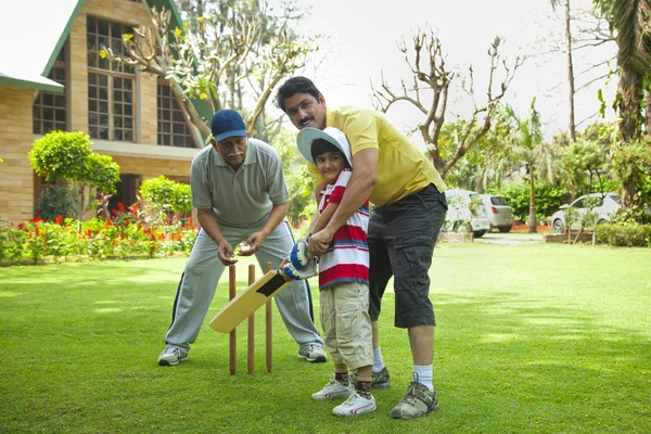 Young boy playing cricket