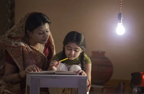 Mother helping daughter study