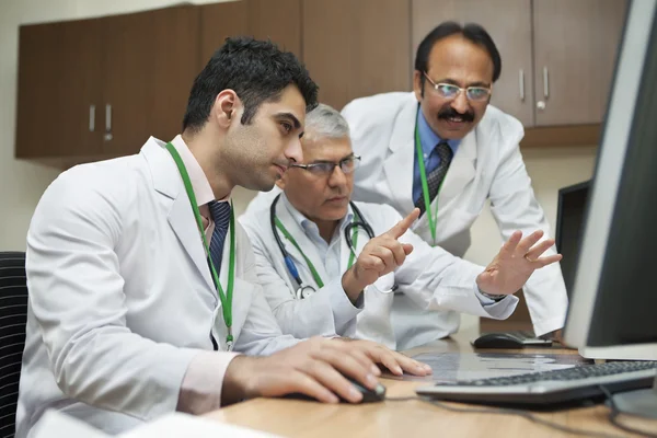 Doctors looking at computer screen