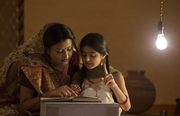Mother helping daughter to study