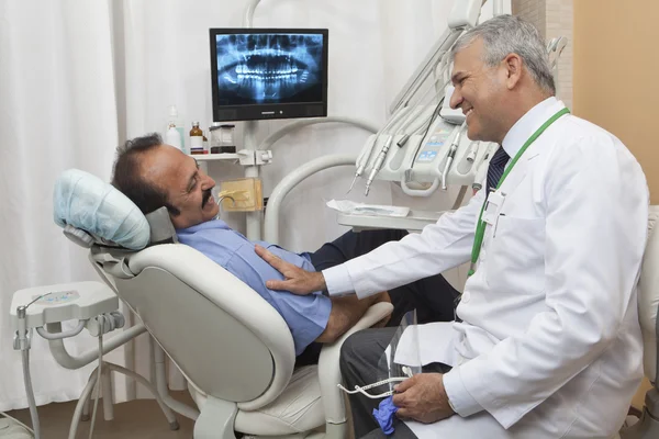 Dentist with patient talking