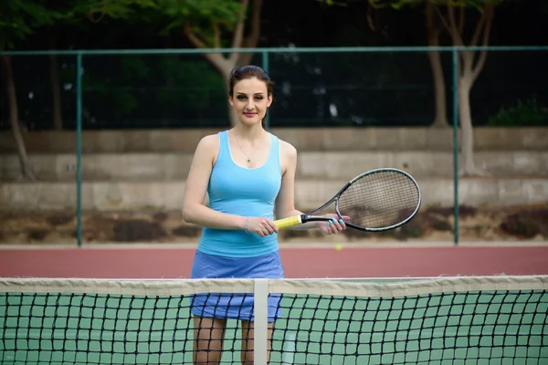 Young beautiful woman tennis player practice in tennis court