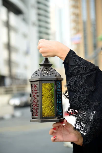 Emarati Arab woman holding Ramadan lantern