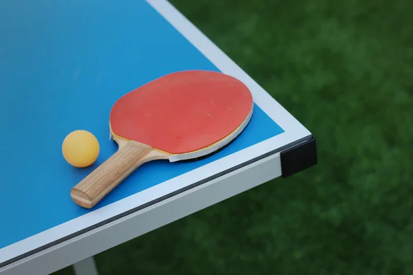 Racket and ball on a table tennis