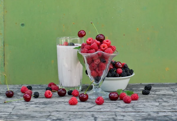 Raspberry, cherry and mulberry on a green background