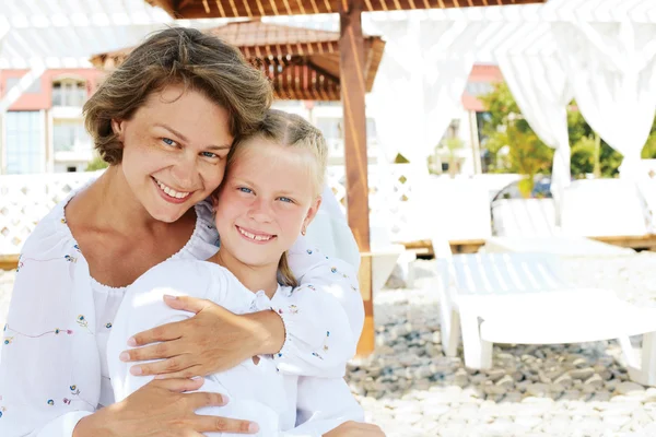 Luxury resort happy family relaxing . Mother and daughter lying