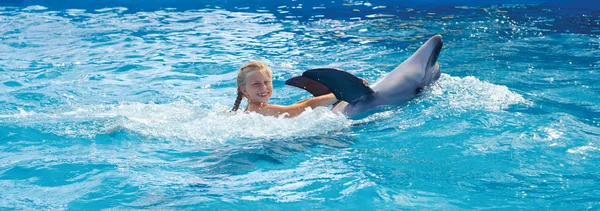 Happy child and dolphins in blue water. Dolphin Assisted Therapy