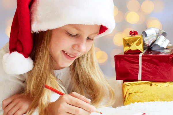 Cute little girl writes letter to Santa Claus