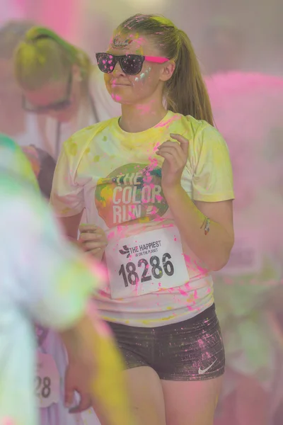 Female runner at the pink color station at the Color Run Tropico