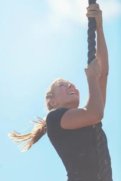 Female climbing the Rope climb at the Tough Viking event at Gard