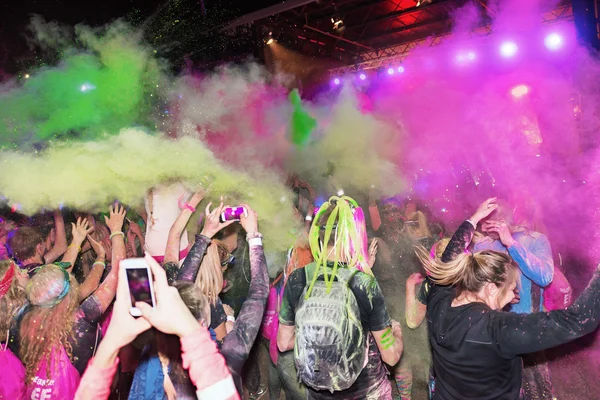 Crowd throws color powder at the Color Run Night Edition in Stoc