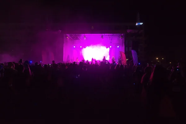 Bright colorful stage with crowd in front at the Color Run Night