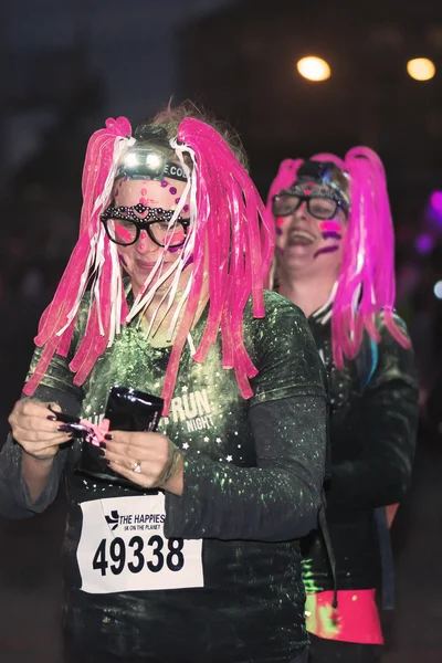 Colorful happy people at the Color Run Night Edition in Stockhol