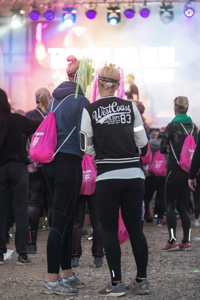 Colorful happy people at the Color Run Night Edition in Stockhol