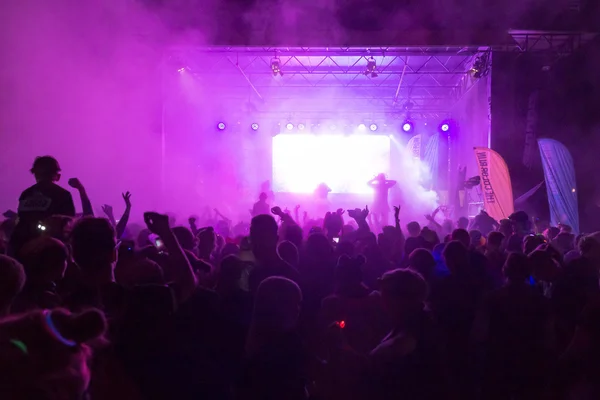 Bright colorful stage with crowd in front at the Color Run Night