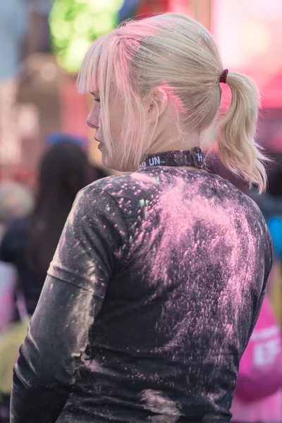 Back of a girls colorful head at the Color Run Night Edition in