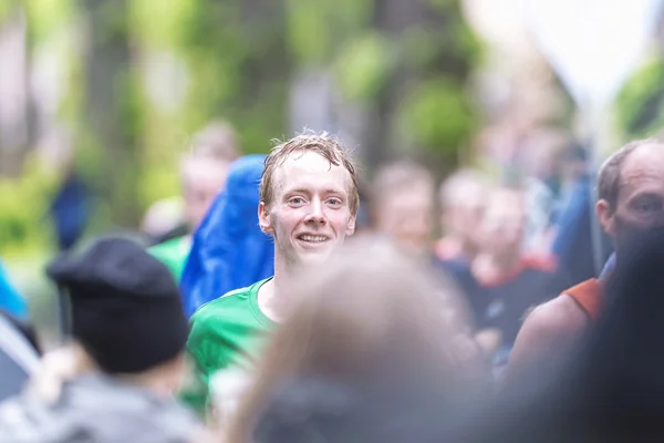 Happy man in the crowd in a lush area at ASICS Stockholm Maratho