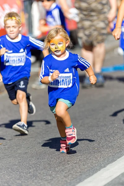 Girl in face painting in front at the Minimil for the youngest r