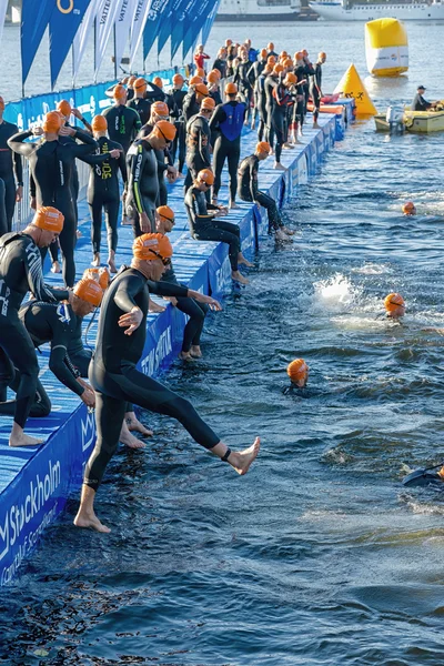 Triathletes jumps into the water for the start in early morning