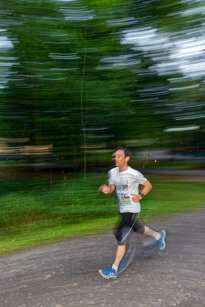 Male runner in motion blur in forest at the event 5K EASD Run Wa