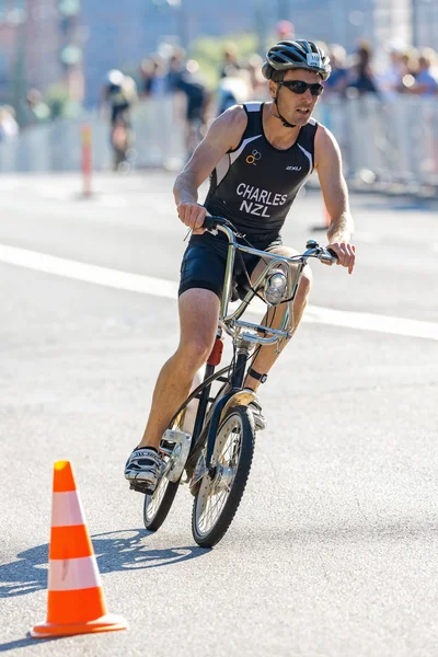 Triathlete Charles from NZL on a hired City bike at the ITU Worl