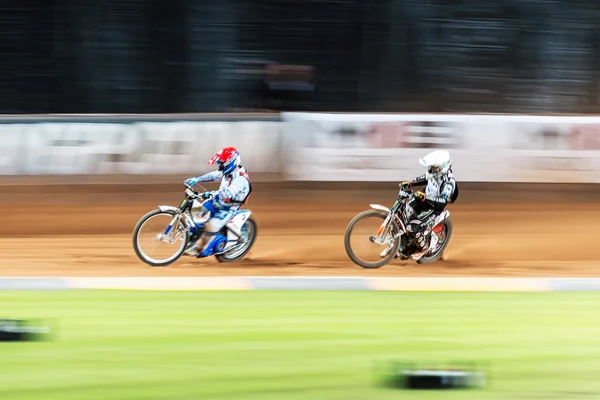 Two speedway racers in action with motion blur at the TEGERA Sto