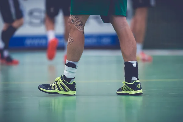 Handball players leg and shoes at the Handball game between Hamm