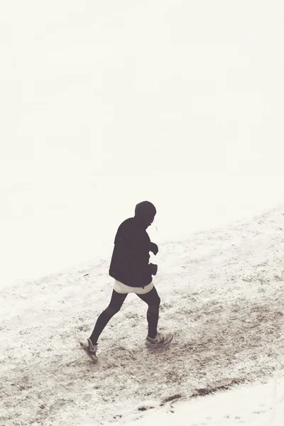 Man running in winter landscape from above