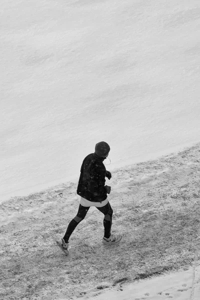 Man running in winter landscape from above